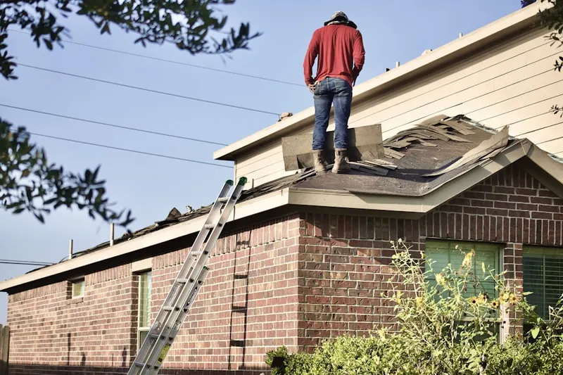 Professional roofer working on a residential roof in Highgrove